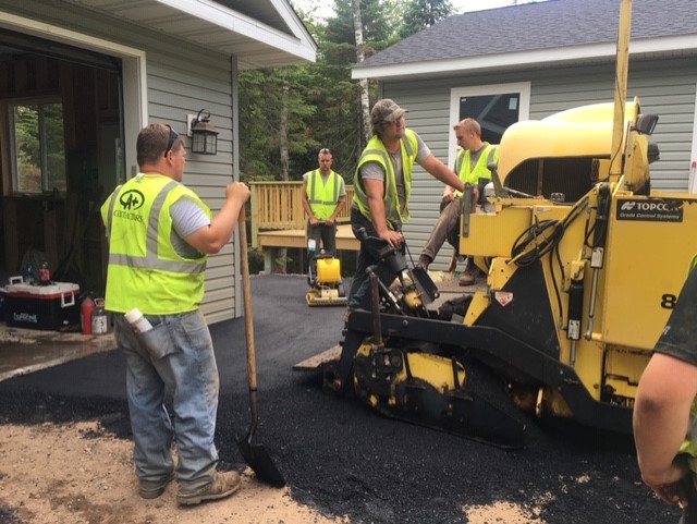 group of aplus contractor workers working on asphalt in the twin ports